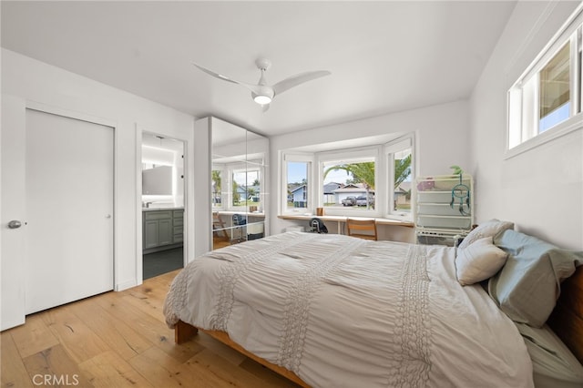 19542 Constellation Ln, Huntington Beach, CA 92646 - bedroom featuring multiple windows, ensuite bathroom, a ceiling fan, and hardwood / wood-style floors