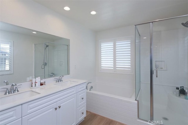 7343 Anise Ln, Chino, CA 91708 - full bathroom featuring a stall shower, a garden tub, wood finished floors, double vanity, and recessed lighting