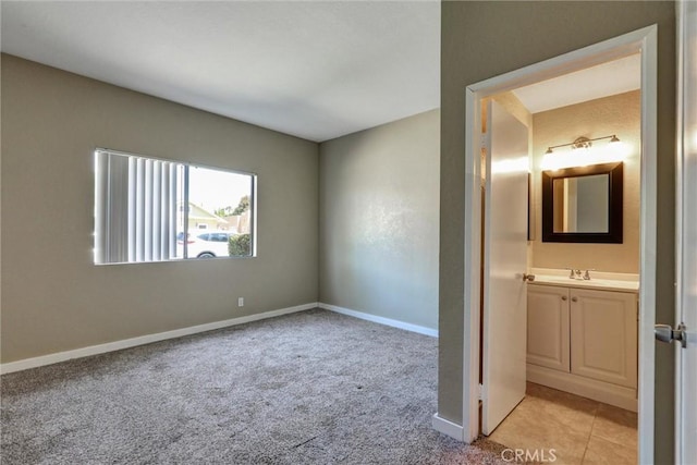 4560 Cleveland Ave Unit 101, San Diego, CA 92116 - unfurnished bedroom with a sink, light carpet, and baseboards