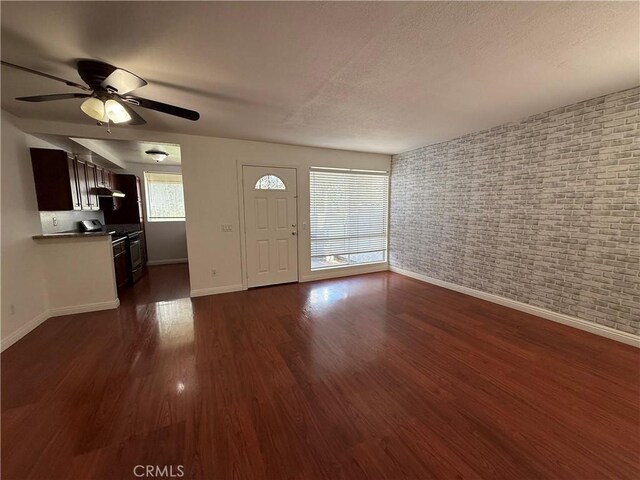 entrance foyer featuring baseboards, ceiling fan, and dark wood finished floors