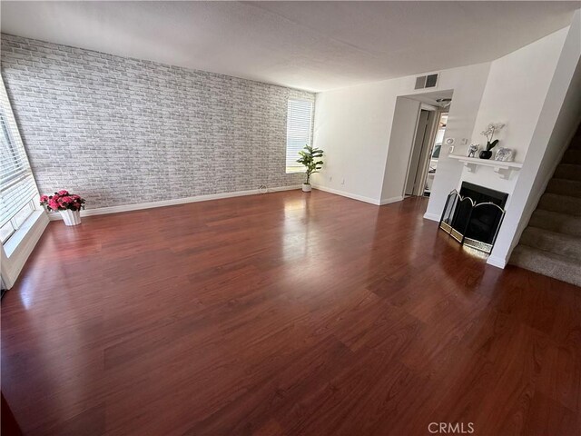 20821 E Calora St Unit E1, Covina, CA 91724 - unfurnished living room featuring a fireplace, baseboards, healthy amount of natural light, and dark wood-type flooring