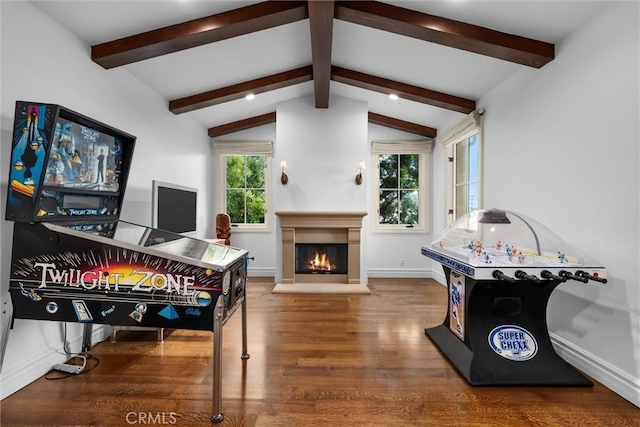game room featuring wood finished floors, a glass covered fireplace, and baseboards