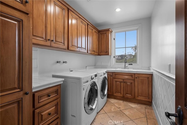 laundry room with cabinet space, independent washer and dryer, recessed lighting, and light tile patterned flooring