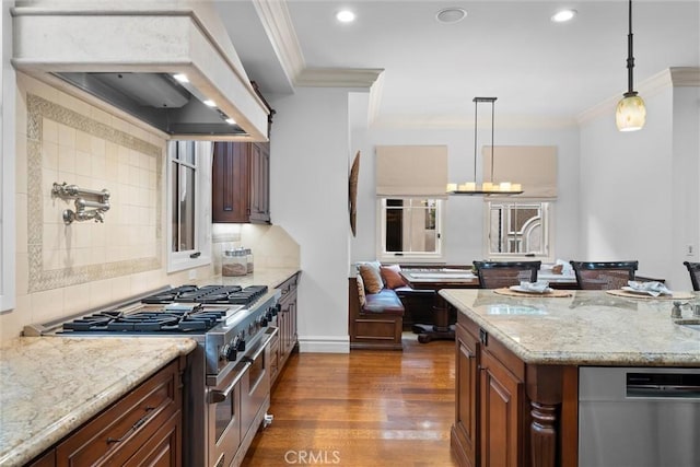 kitchen featuring appliances with stainless steel finishes, crown molding, dark wood-style floors, light stone counters, and recessed lighting