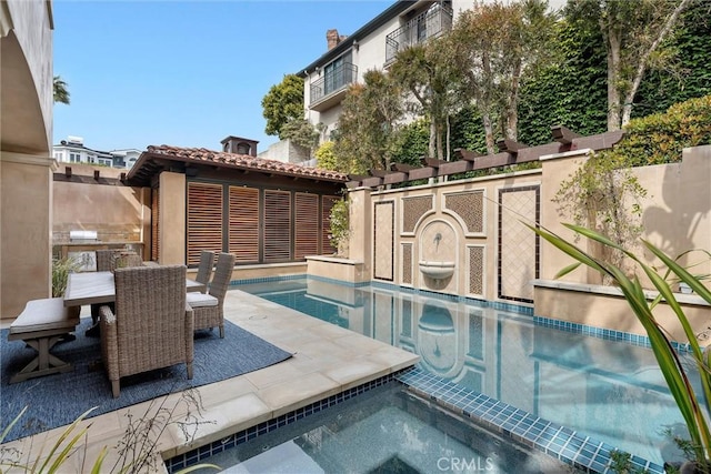 view of pool with area for grilling, an in-ground hot tub, outdoor dining space, and a patio area