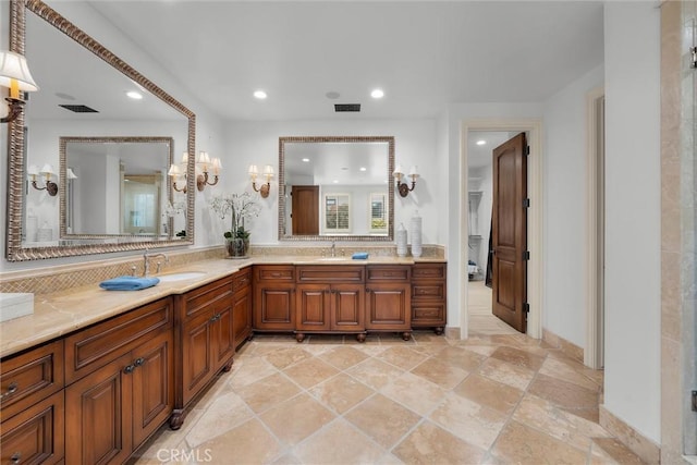 bathroom with recessed lighting, vanity, baseboards, and tasteful backsplash