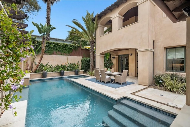 view of swimming pool with a patio area and fence