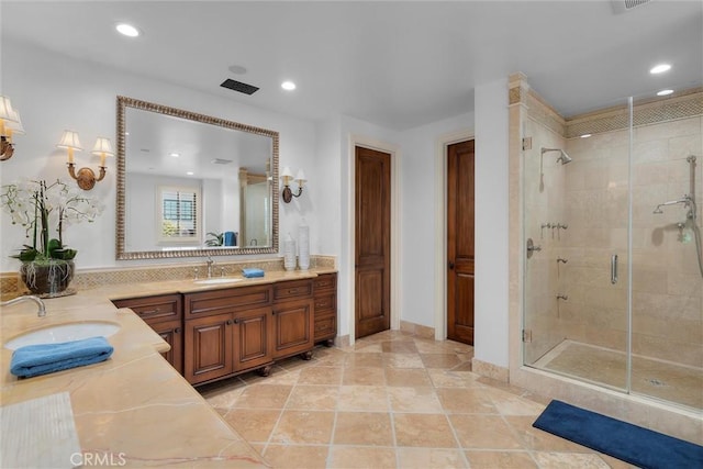 full bath featuring a stall shower, recessed lighting, and vanity