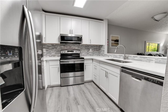 3955 Faircross Pl Unit 48, San Diego, CA 92115 - kitchen featuring a sink, stainless steel appliances, light countertops, and white cabinets