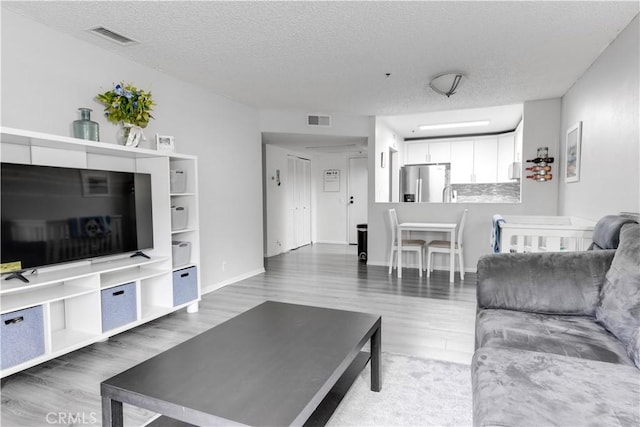 3955 Faircross Pl Unit 48, San Diego, CA 92115 - living area with a textured ceiling, visible vents, and wood finished floors