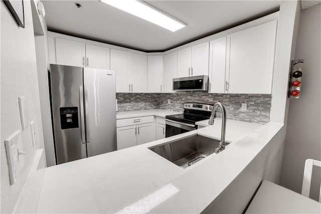 3955 Faircross Pl Unit 48, San Diego, CA 92115 - kitchen featuring a sink, tasteful backsplash, white cabinetry, light countertops, and appliances with stainless steel finishes
