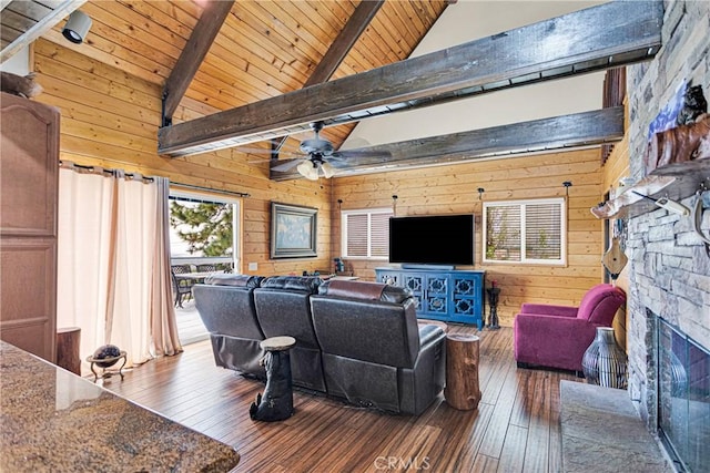 28935 Banff Dr, Lake Arrowhead, CA 92352 - living room with a ceiling fan, wood-type flooring, beam ceiling, wood walls, and a stone fireplace