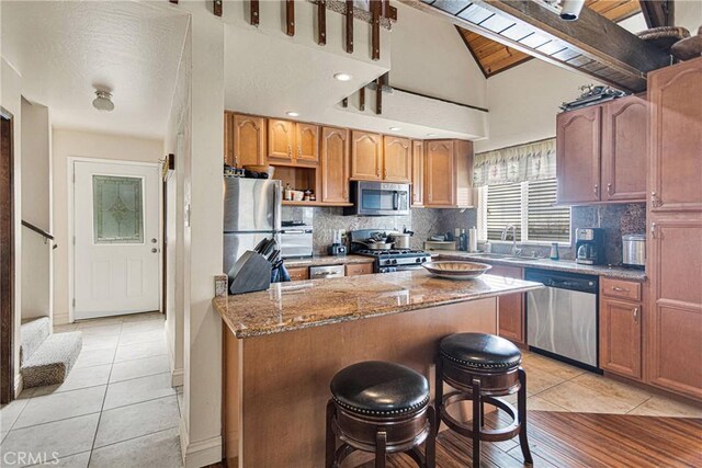28935 Banff Dr, Lake Arrowhead, CA 92352 - kitchen with a sink, tasteful backsplash, light tile patterned flooring, light stone counters, and appliances with stainless steel finishes
