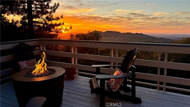 28935 Banff Dr, Lake Arrowhead, CA 92352 - deck at dusk featuring a fire pit