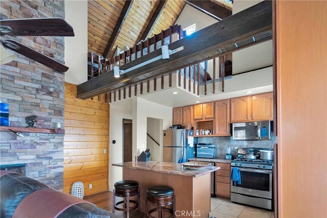 28935 Banff Dr, Lake Arrowhead, CA 92352 - kitchen with high vaulted ceiling, stainless steel appliances, a kitchen breakfast bar, beamed ceiling, and wooden ceiling