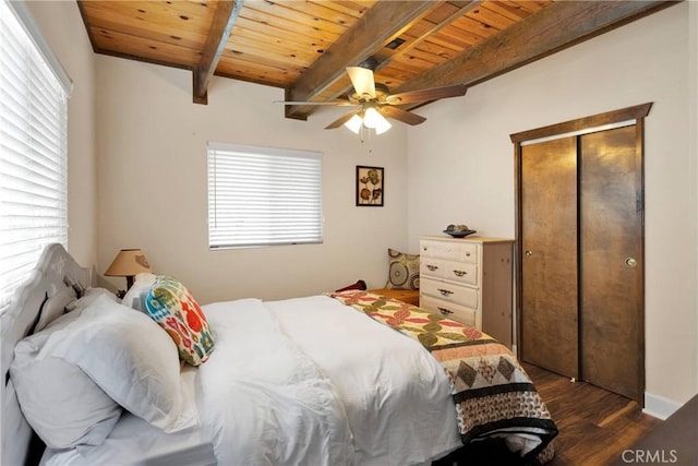 28935 Banff Dr, Lake Arrowhead, CA 92352 - bedroom with a closet, beam ceiling, dark wood-style flooring, ceiling fan, and wood ceiling