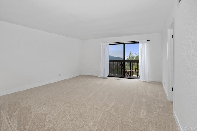 empty room with carpet and baseboards