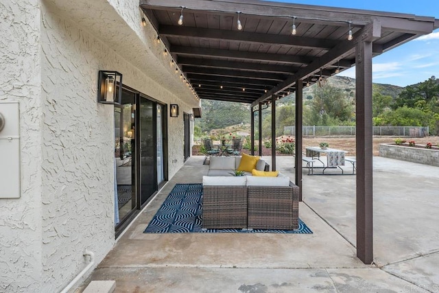 view of patio / terrace featuring an outdoor hangout area and fence