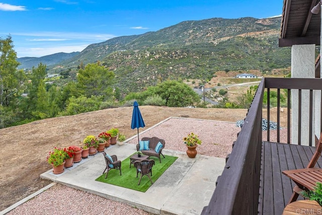view of yard featuring a patio area and a mountain view