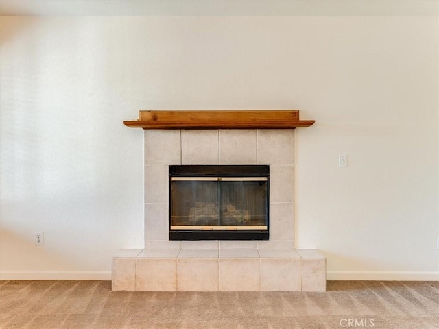 interior details featuring a fireplace, carpet floors, and baseboards