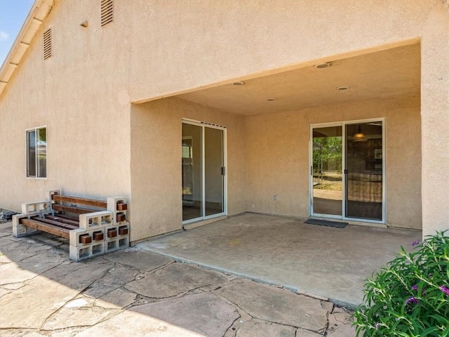 back of property featuring a patio area and stucco siding