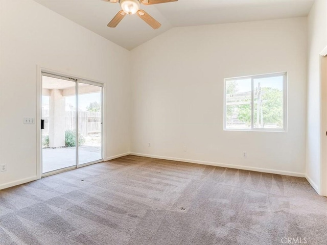 unfurnished room featuring vaulted ceiling, carpet flooring, baseboards, and a ceiling fan