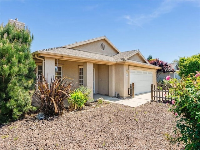 single story home with concrete driveway, stucco siding, an attached garage, and fence