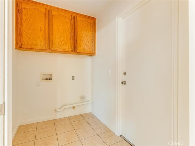 clothes washing area featuring cabinet space, hookup for a washing machine, light tile patterned floors, and hookup for a gas dryer