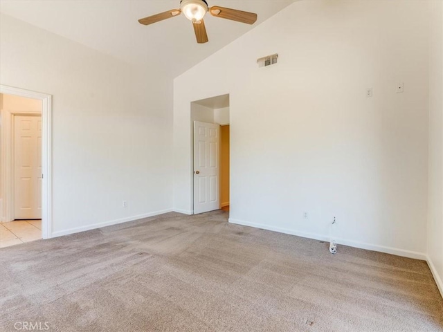 spare room featuring a ceiling fan, light carpet, high vaulted ceiling, and baseboards