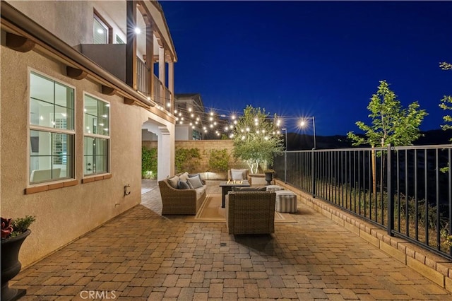 29034 Via Patina, Valencia, CA 91354 - patio at night with an outdoor hangout area, a patio, and a balcony