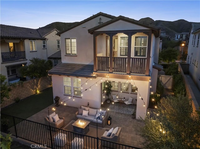29034 Via Patina, Valencia, CA 91354 - rear view of property with a balcony, an outdoor living space with a fire pit, stucco siding, and a patio
