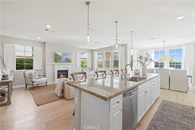 29034 Via Patina, Valencia, CA 91354 - kitchen with stainless steel dishwasher, light wood-style floors, an island with sink, plenty of natural light, and recessed lighting