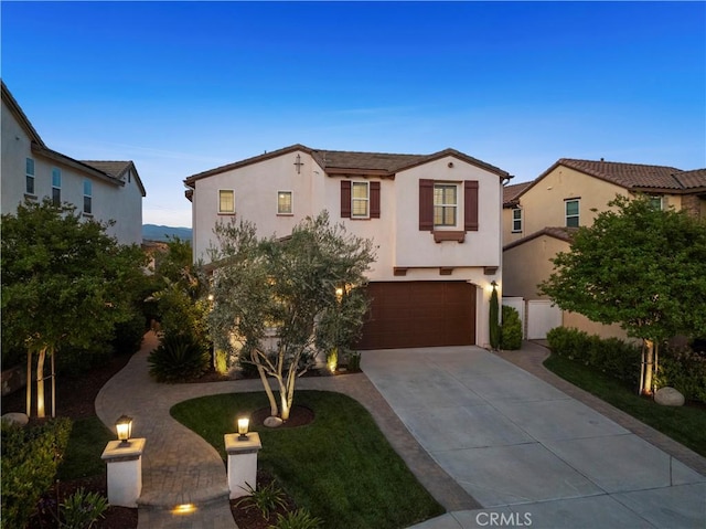 29034 Via Patina, Valencia, CA 91354 - mediterranean / spanish-style home featuring concrete driveway, stucco siding, and an attached garage