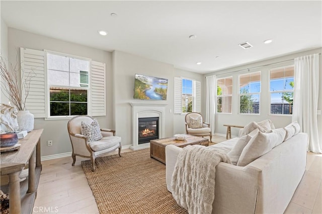 29034 Via Patina, Valencia, CA 91354 - living room with a glass covered fireplace, light wood-type flooring, and recessed lighting