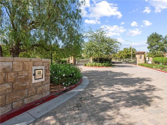 29034 Via Patina, Valencia, CA 91354 - view of community with a gate, decorative driveway, and fence