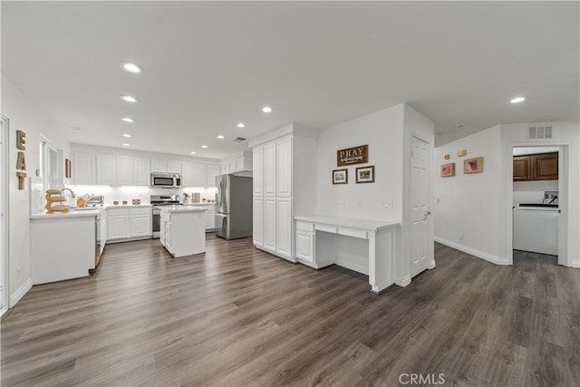 28823 Tonya St, Murrieta, CA 92563 - kitchen with white cabinets, appliances with stainless steel finishes, visible vents, and washer / clothes dryer