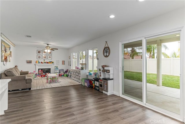 28823 Tonya St, Murrieta, CA 92563 - living area with wood finished floors, a fireplace, visible vents, ceiling fan, and recessed lighting