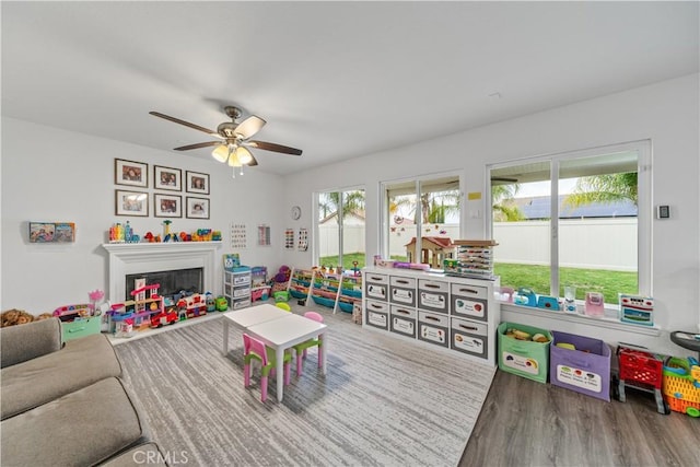 28823 Tonya St, Murrieta, CA 92563 - recreation room featuring a fireplace, ceiling fan, and wood finished floors