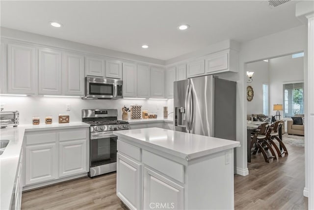 28823 Tonya St, Murrieta, CA 92563 - kitchen featuring white cabinets, appliances with stainless steel finishes, light wood-style flooring, and recessed lighting