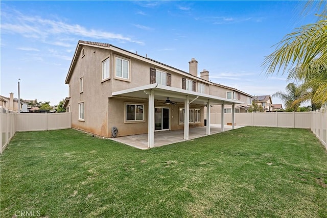 28823 Tonya St, Murrieta, CA 92563 - back of property with a fenced backyard, stucco siding, a ceiling fan, and a lawn