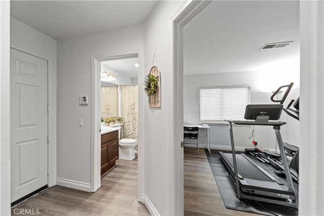 28823 Tonya St, Murrieta, CA 92563 - workout area with light wood-style flooring, baseboards, and visible vents