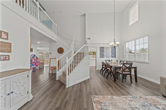 28823 Tonya St, Murrieta, CA 92563 - dining area featuring stairs, a notable chandelier, a high ceiling, and wood finished floors