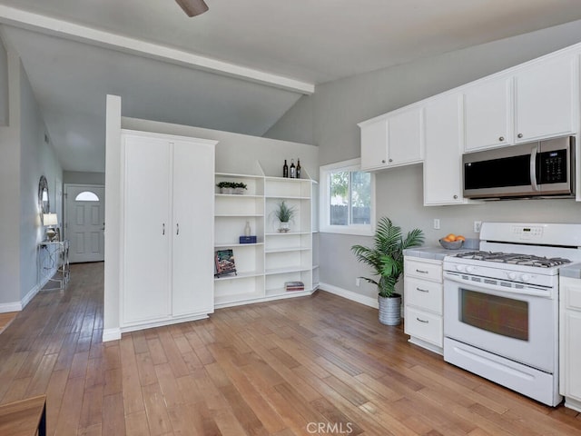 22661 Claude Cir, Lake Forest, CA 92630 - kitchen featuring gas range gas stove, stainless steel microwave, light wood-style flooring, white cabinets, and light countertops