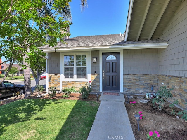 22661 Claude Cir, Lake Forest, CA 92630 - doorway to property featuring a lawn, stone siding, and a shingled roof
