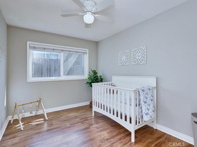 22661 Claude Cir, Lake Forest, CA 92630 - bedroom featuring wood finished floors, a nursery area, and ceiling fan