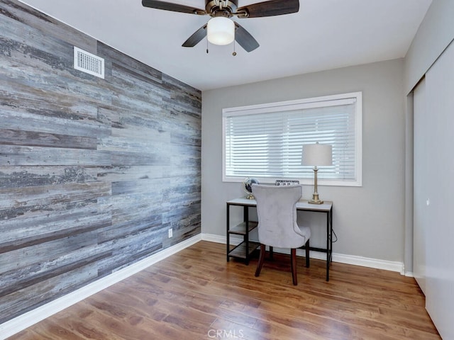 22661 Claude Cir, Lake Forest, CA 92630 - office area with wooden walls, an accent wall, ceiling fan, and wood finished floors