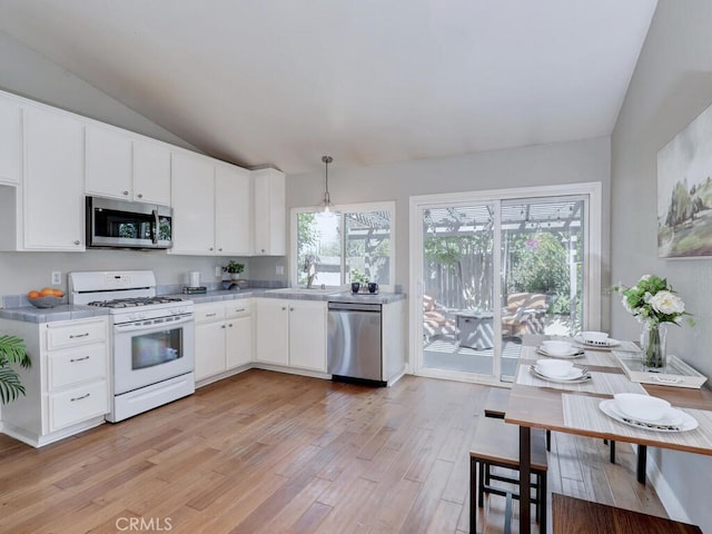 22661 Claude Cir, Lake Forest, CA 92630 - kitchen with appliances with stainless steel finishes, light wood-type flooring, lofted ceiling, light countertops, and white cabinetry