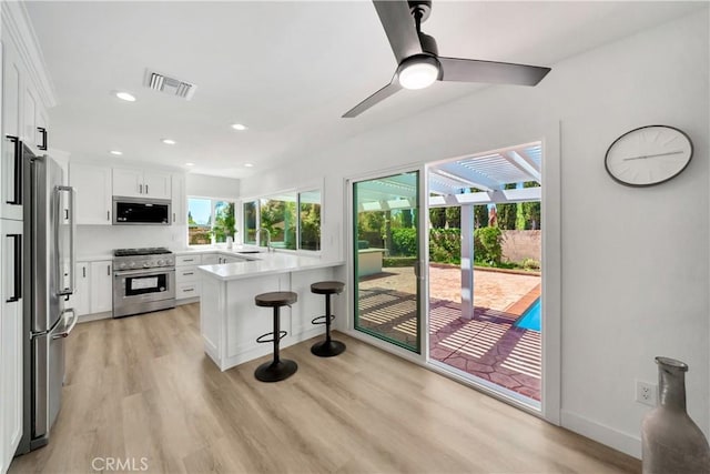 1760 N Yurok St, Orange, CA 92867 - kitchen featuring a breakfast bar area, visible vents, a sink, a peninsula, and appliances with stainless steel finishes
