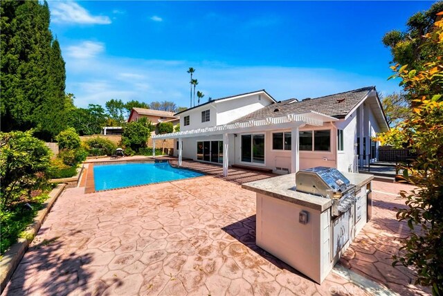 1760 N Yurok St, Orange, CA 92867 - view of swimming pool featuring fence, a grill, a pergola, a fenced in pool, and an outdoor kitchen