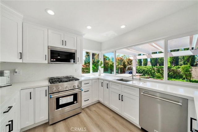 1760 N Yurok St, Orange, CA 92867 - kitchen with light countertops, stainless steel appliances, white cabinets, and a sink